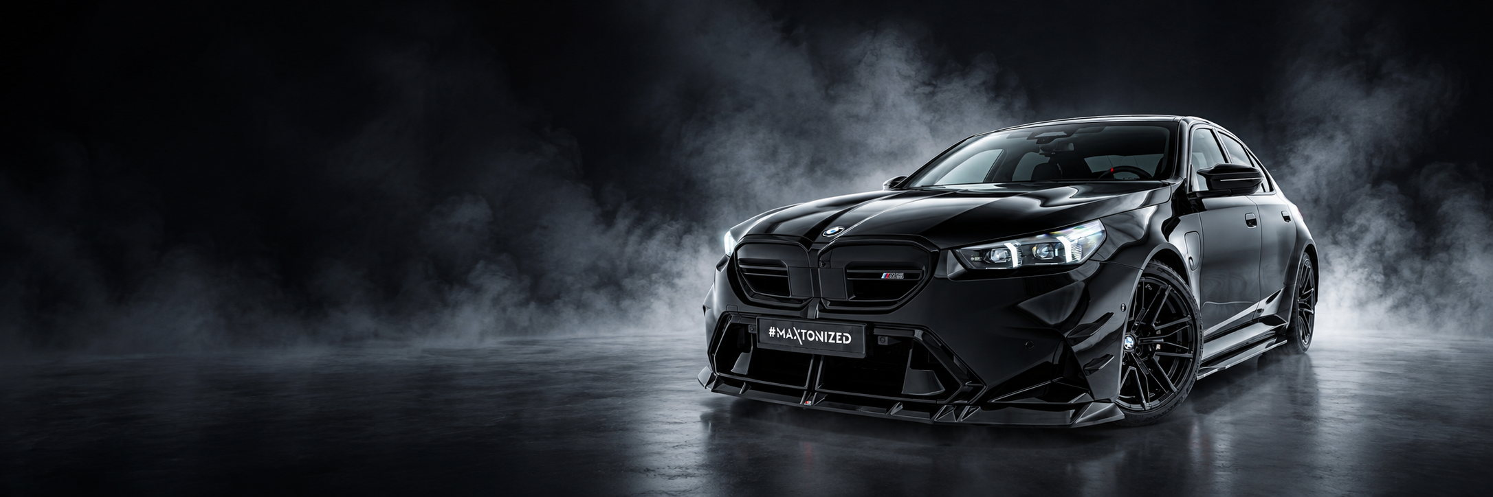 Black BMW M5 G90 with Maxton Design front splitter V.1 in a smoky studio